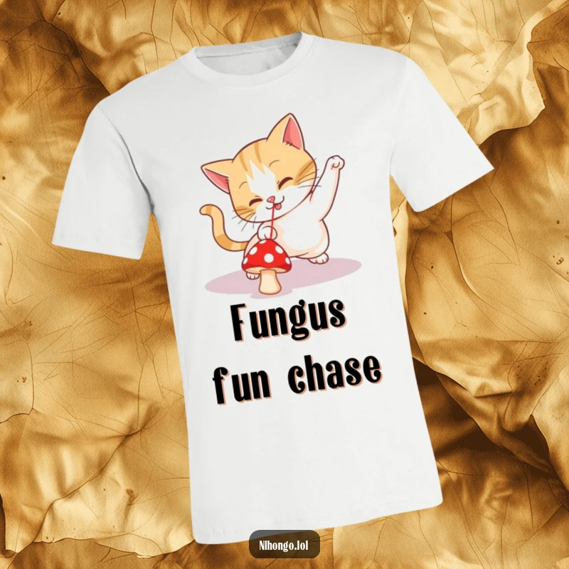 Funny t-shirt showing a determined cat leaping and playing, focused on a tiny red mushroom mistaken for a laser pointer.